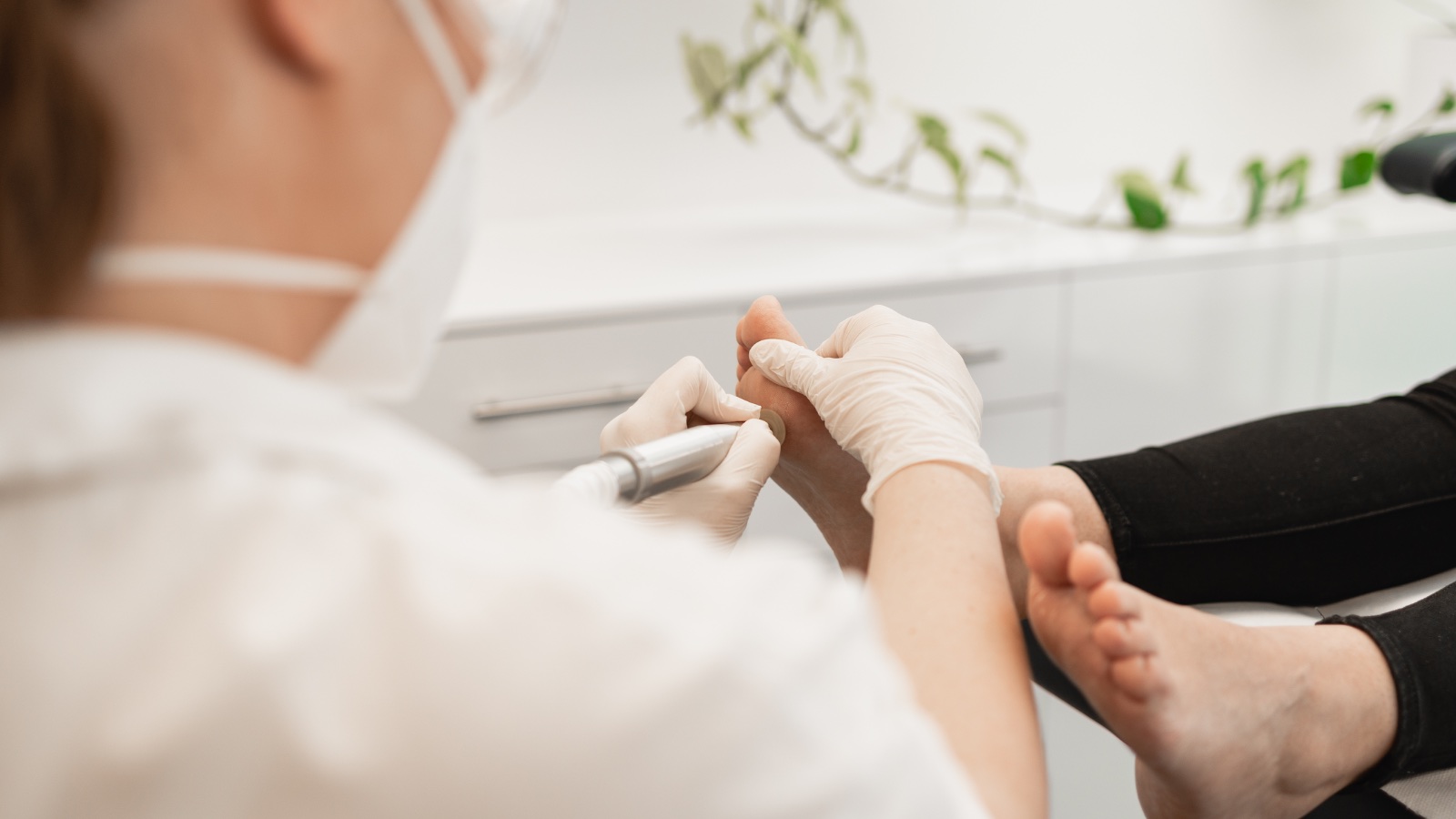 Podiatrist treating a patient during a home visit in Adelaide