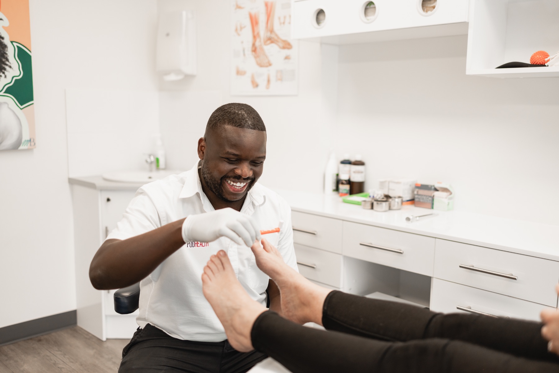 Foot treatment during a podiatry appointment at Podhealth